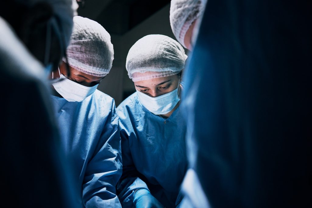 Hospital, surgery and team of doctors in theatre for medical support, teamwork or healthcare soluti