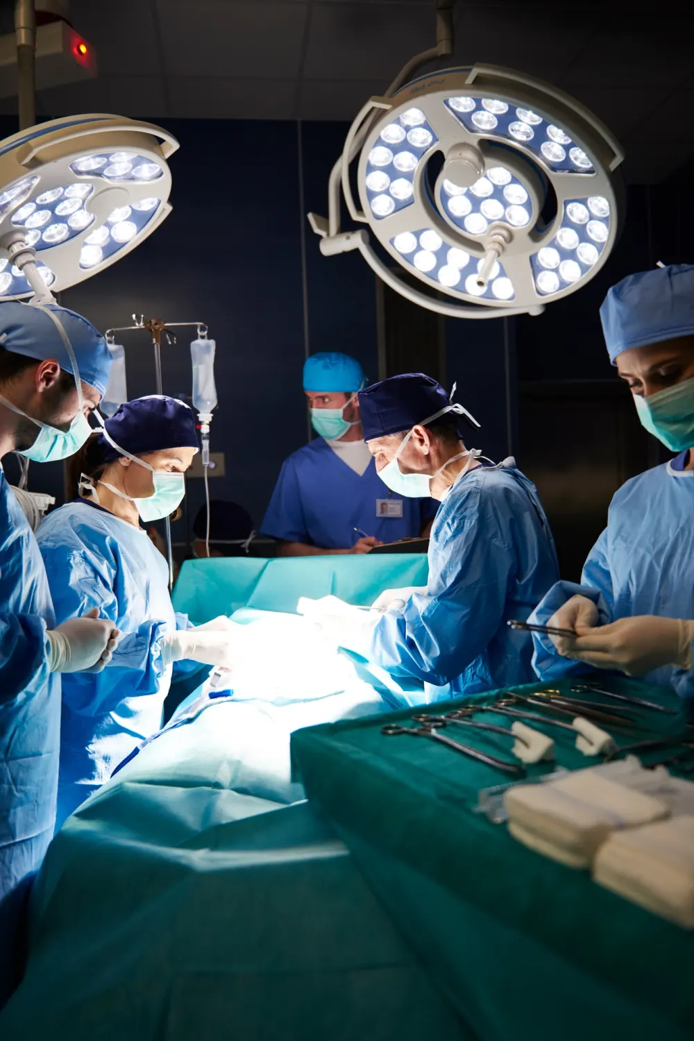 Dark operating room and surgeons